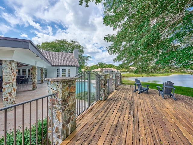 wooden terrace featuring a water view