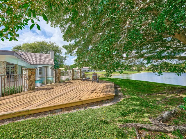 view of yard with a deck with water view