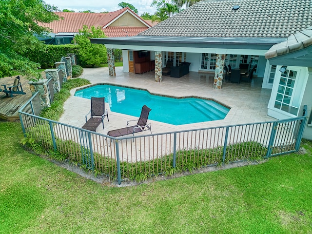 view of pool with a patio area and a lawn