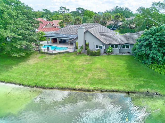 exterior space with a front yard, a patio, and a water view