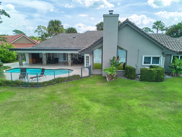 view of swimming pool with a patio and a lawn