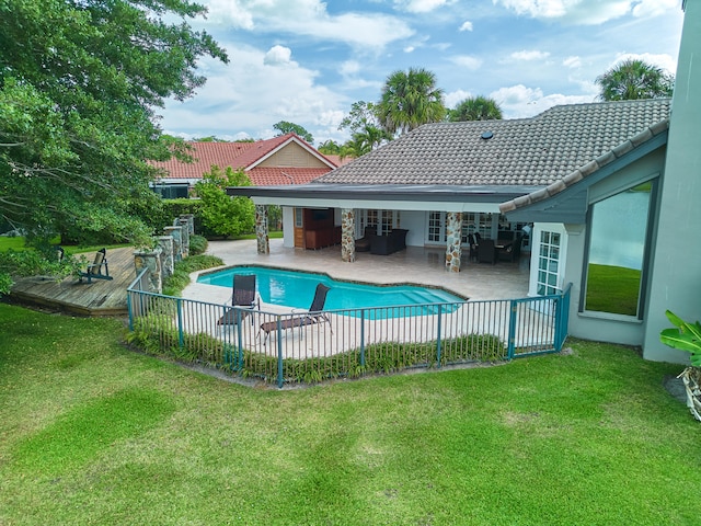 view of swimming pool with a patio area, a yard, and a deck