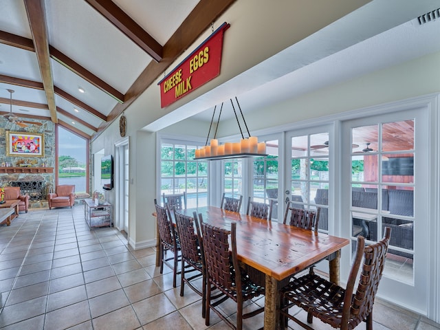 dining area featuring lofted ceiling with beams, ceiling fan, and light tile floors