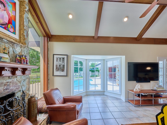 interior space featuring plenty of natural light, light tile flooring, ceiling fan, and beam ceiling