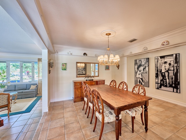 tiled dining area featuring crown molding and an inviting chandelier