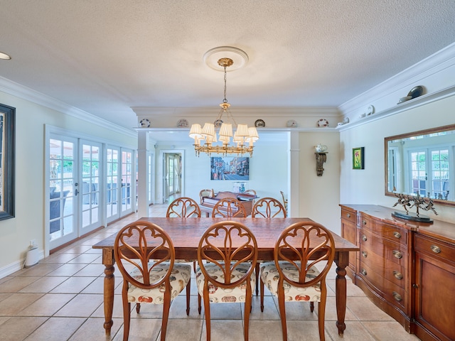 dining area featuring a notable chandelier, light tile flooring, and ornamental molding