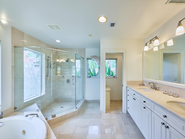 bathroom featuring tile flooring, double vanity, and separate shower and tub