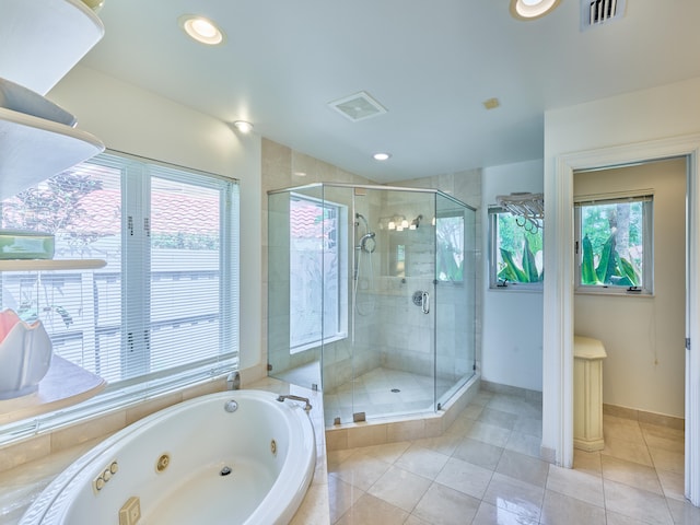 bathroom with an enclosed shower and tile floors