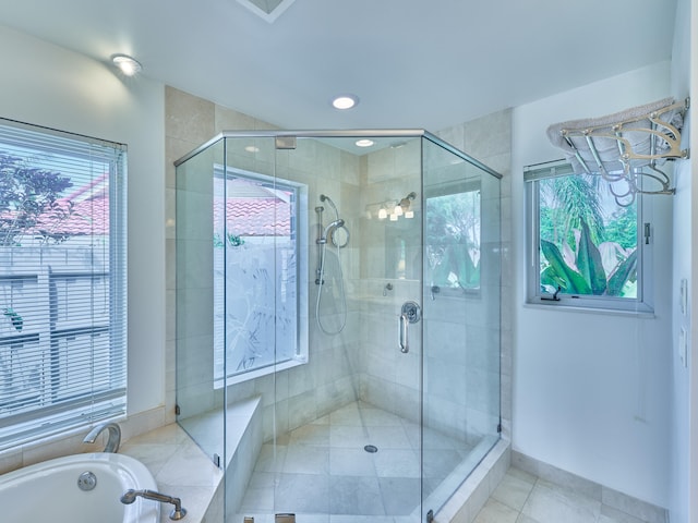 bathroom with plenty of natural light, tile floors, and separate shower and tub