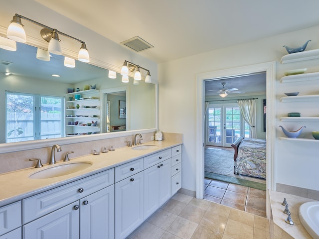 bathroom with a bathtub, ceiling fan, tile floors, and double sink vanity