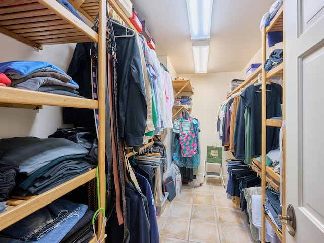 walk in closet featuring light tile floors