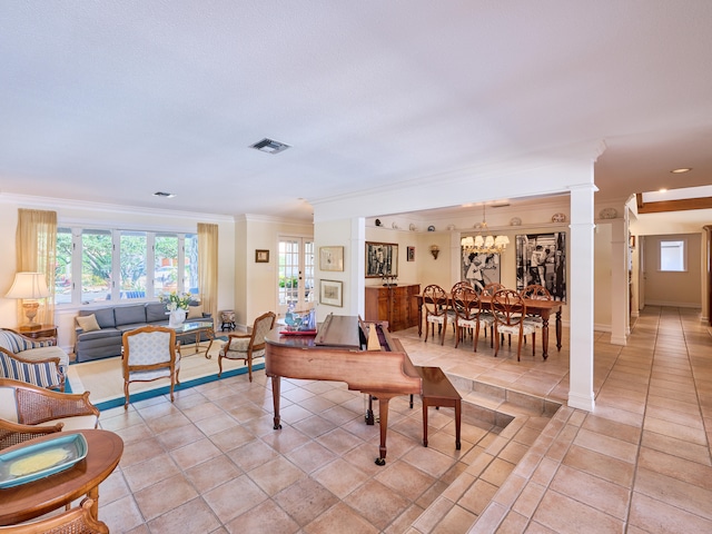 living room with ornamental molding, an inviting chandelier, light tile flooring, and decorative columns