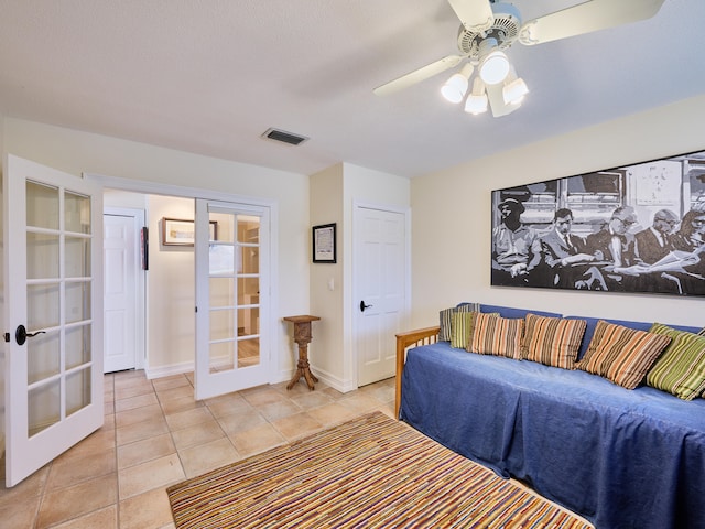 tiled living room featuring french doors and ceiling fan