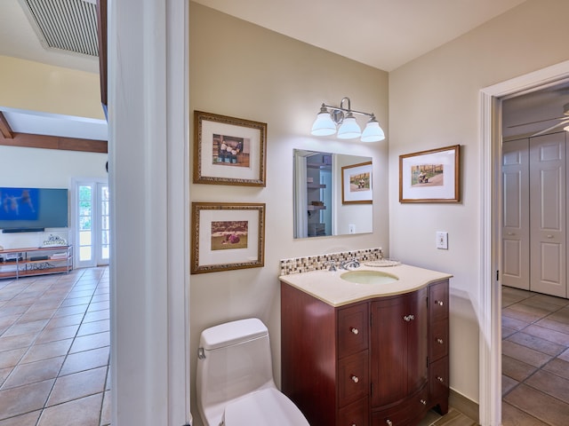 bathroom featuring tile floors, toilet, and oversized vanity