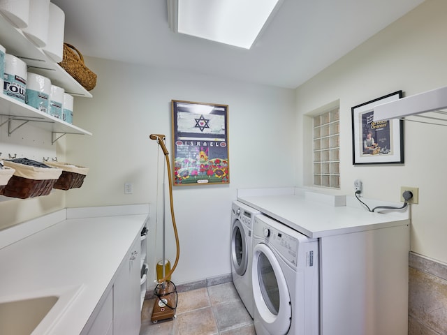 laundry room featuring washing machine and dryer, cabinets, and light tile floors