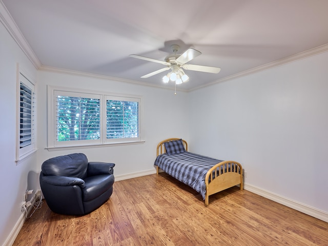 bedroom featuring ornamental molding, ceiling fan, and light wood-type flooring