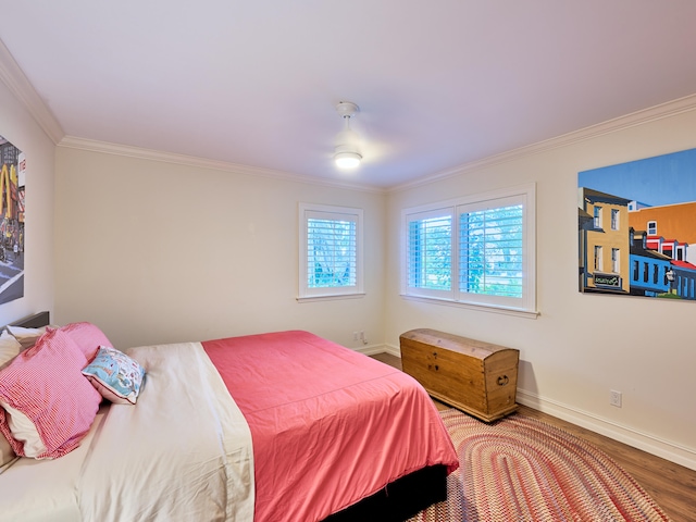 bedroom with wood-type flooring and crown molding