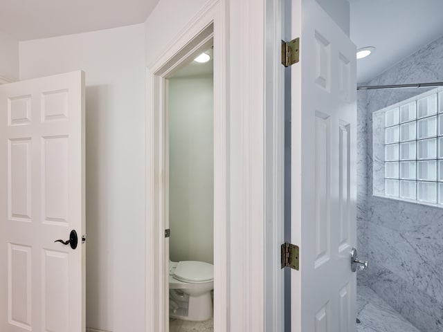 bathroom with tile floors and toilet