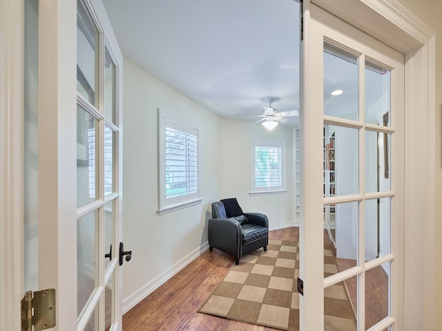 living area featuring wood-type flooring, french doors, and ceiling fan