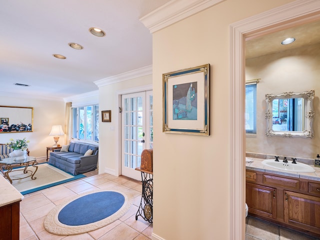 interior space with crown molding, tile flooring, and vanity