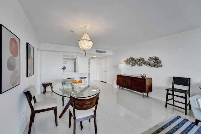 tiled dining area featuring an inviting chandelier