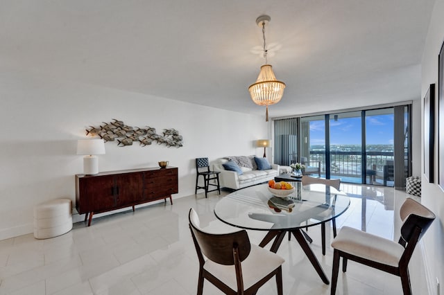 dining room featuring an inviting chandelier, a wall of windows, and light tile flooring