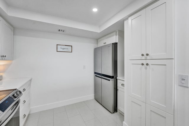 kitchen with white cabinets, stainless steel appliances, and light tile flooring