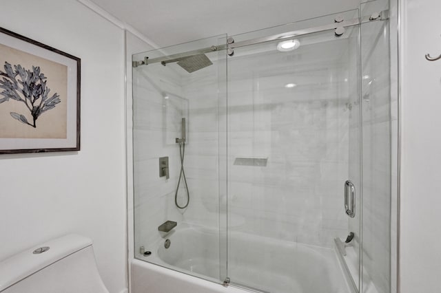 bathroom with shower / bath combination with glass door and toilet