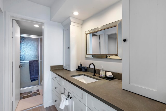 bathroom featuring oversized vanity and hardwood / wood-style flooring