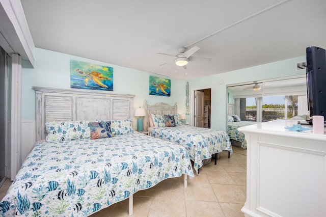 tiled bedroom featuring ceiling fan