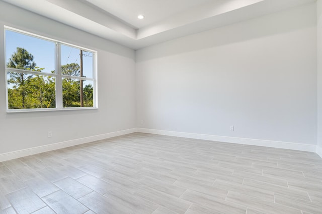 unfurnished room featuring a tray ceiling