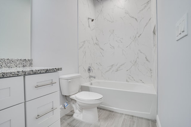 full bathroom with toilet, vanity, and tiled shower / bath