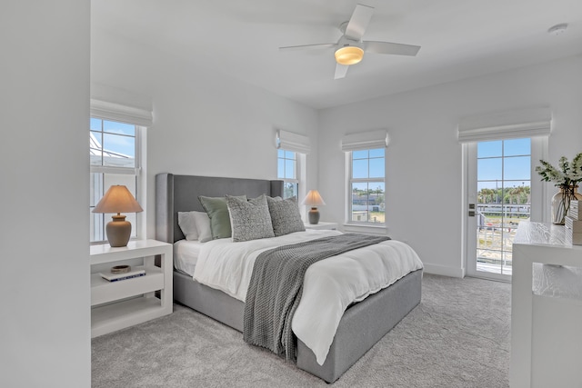 carpeted bedroom featuring ceiling fan, access to outside, and baseboards