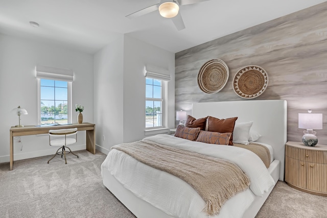 bedroom with baseboards, ceiling fan, and light colored carpet