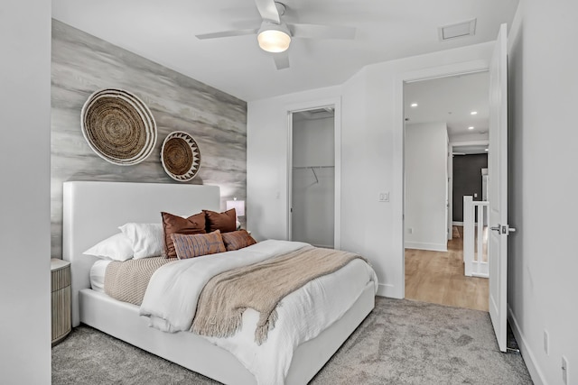 bedroom with a closet, recessed lighting, a ceiling fan, carpet floors, and visible vents