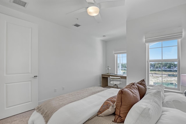 bedroom featuring a ceiling fan, visible vents, and carpet floors