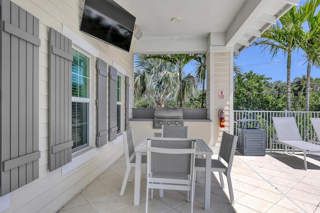 view of patio with area for grilling and outdoor dining area