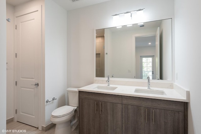 bathroom featuring hardwood / wood-style floors, vanity, and toilet