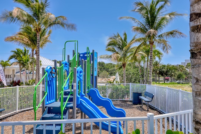 community jungle gym featuring fence