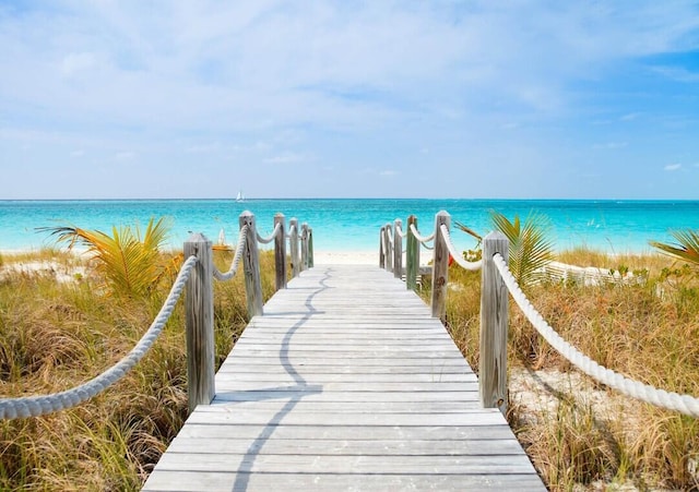 exterior space featuring a beach view and a water view
