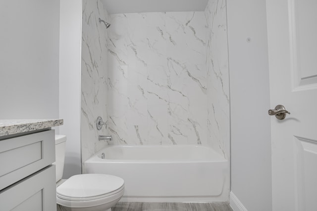 full bathroom featuring tiled shower / bath combo, toilet, and vanity