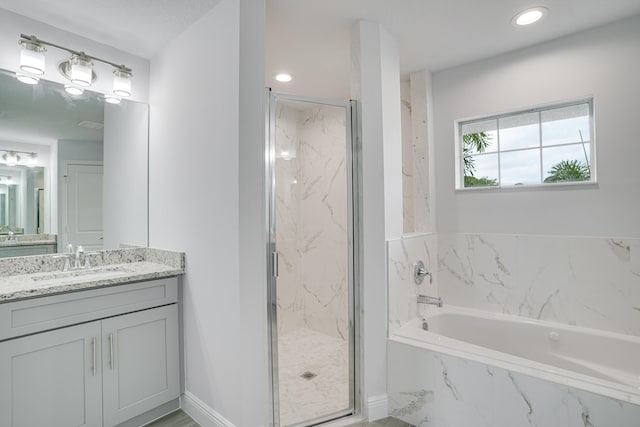 bathroom with separate shower and tub and vanity