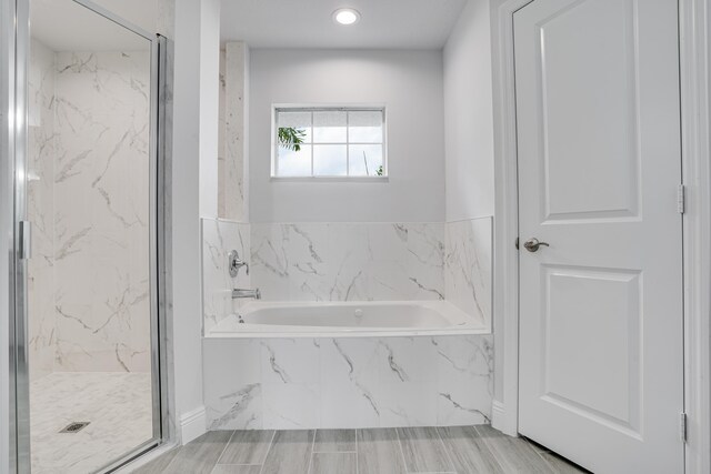 bathroom with tile flooring and plus walk in shower