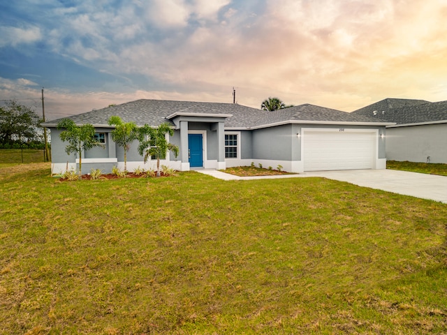 view of front of house with a yard and a garage