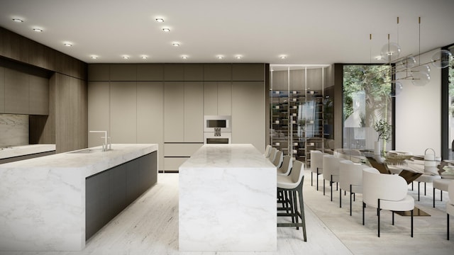 kitchen with a kitchen island with sink and modern cabinets