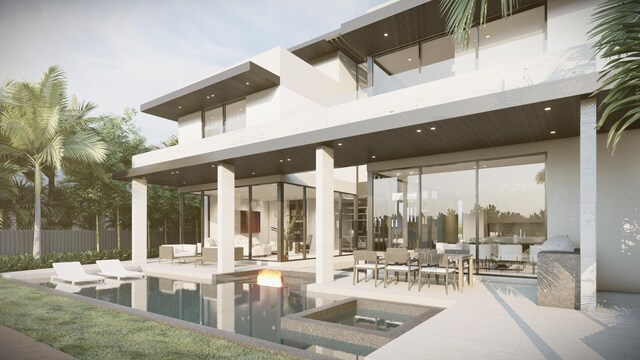 exterior space with stucco siding, fence, a fenced in pool, and a patio