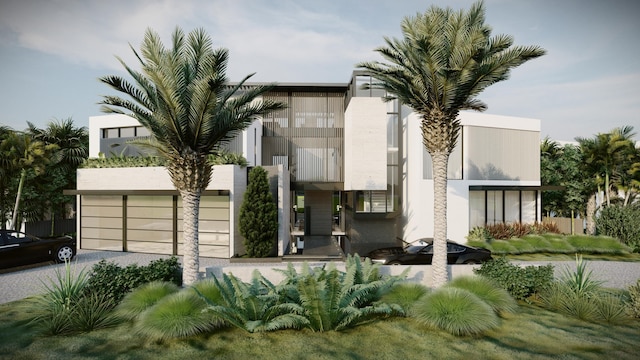 view of front of house featuring driveway, an attached garage, and stucco siding