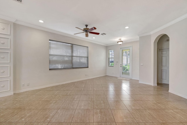 tiled spare room with ceiling fan and crown molding