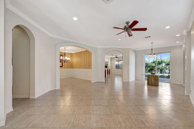 unfurnished room featuring ceiling fan with notable chandelier, ornamental molding, and light tile flooring