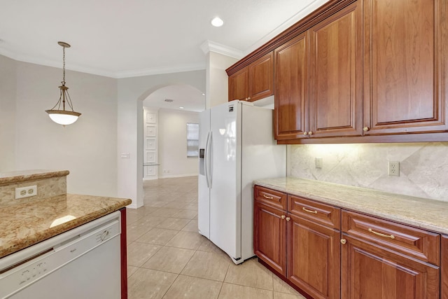 kitchen with decorative light fixtures, white appliances, light tile floors, and light stone counters